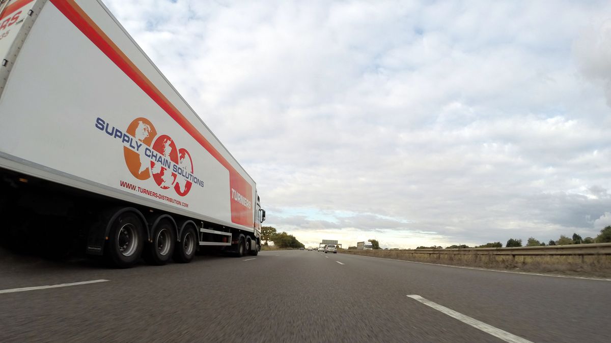 Tractor and freight trailer traveling on a highway