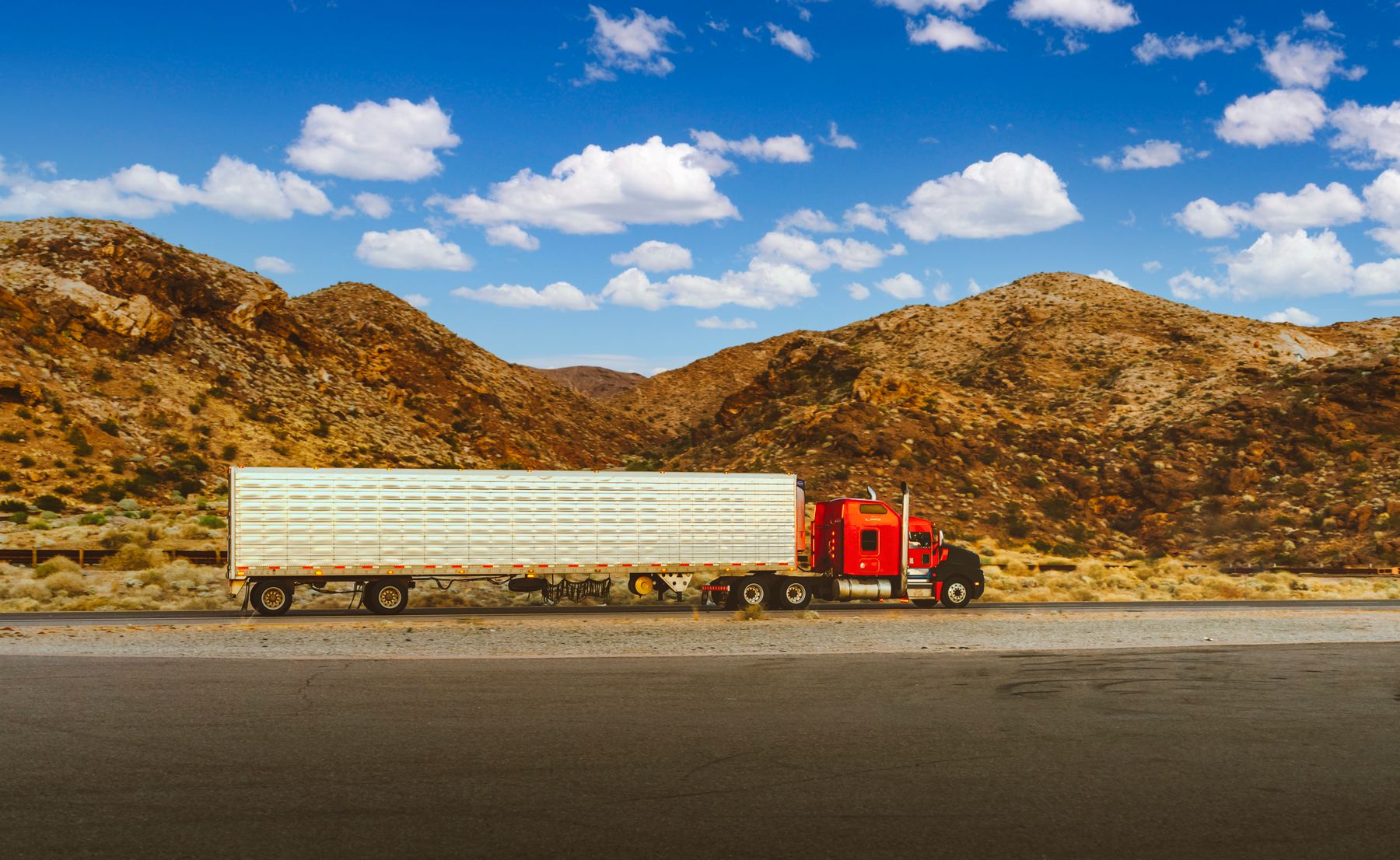 Red semi truck on the open road